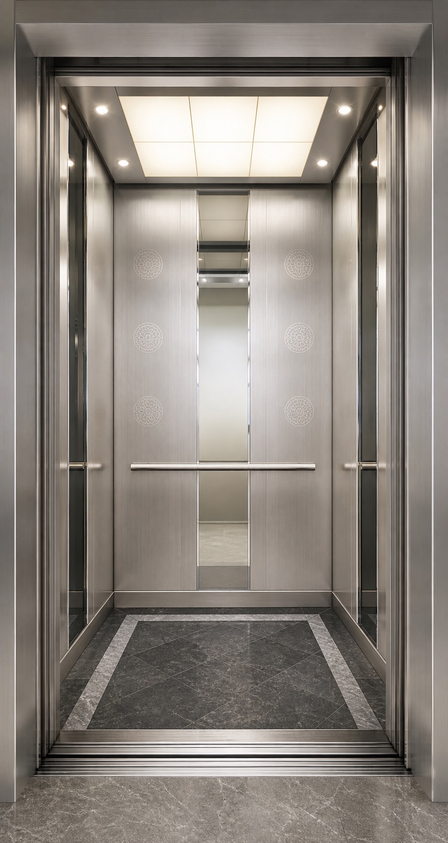 Actual stainless-steel elevator cabin with etched circular detailing and mirror accents
